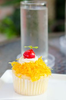  thai sweetmeat or call it " cake foi thong" in front of water glass