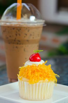 gold egg yolks thread cake, thai sweetmeat in front of ice coffee