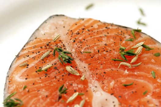 salmon steak with spices: thyme, pepper, fenchel, salt