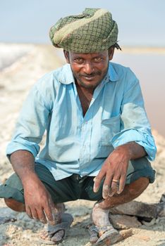 Sambhar, India - Nov 19: Portrait of indian male worker in salt farm on Nov 19, 2012 in Sambhar Salt Lake, India. It is India's largest saline lake and where salt has been farmed for a thousand years. 
