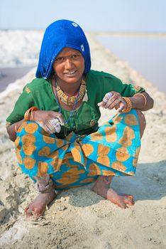 Sambhar, India - Nov 19: Portrait of indian female worker in salt farm on Nov 19, 2012 in Sambhar Salt Lake, India. It is India's largest saline lake, where salt has been farmed for a thousand years. 