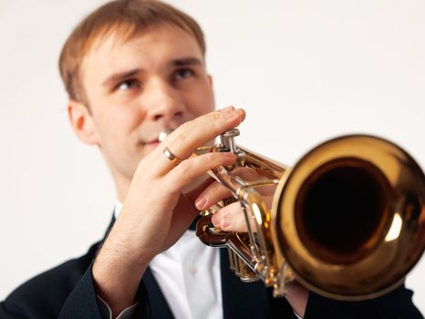 Closeup of the hands of an European musician playing the trumpet