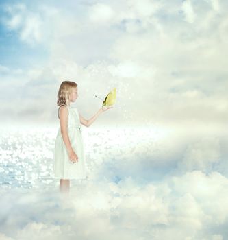 Little girl holding a butterfly on the clouds