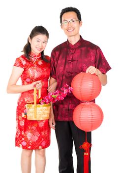 Happy Chinese New Year. Asian Chinese couple with red paper lantern and basket, standing over white background