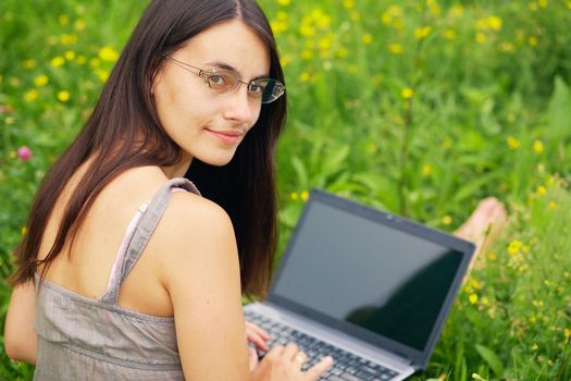 Close-up portrait of a woman with laptop outdoors