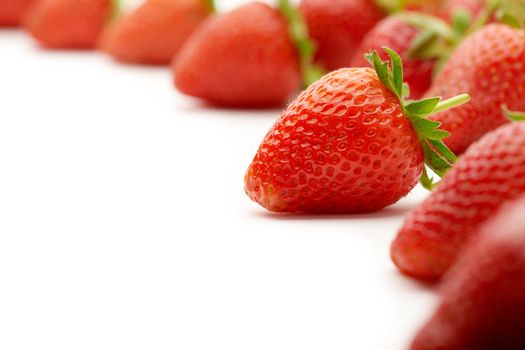 Strawberries with green leaves.This image is focused on one of them