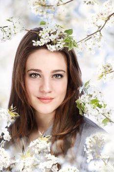 Portrait of a Beautiful Girl with a Blooming Tree