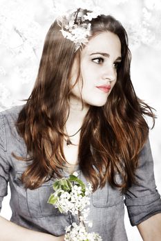 Portrait of a Beautiful Girl with Flowers and a Blooming Tree