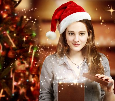 Happy Girl with Santa Hat Opening a Gift Box