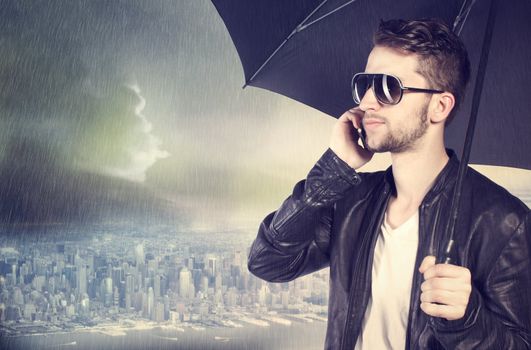 Stylish man talking on his cellphone in the rain