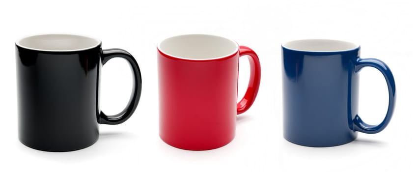 Set of black, red and blue cups on a white background