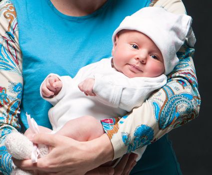 smiling baby in mother's hands