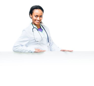 Smiling attractive female doctor with board on a white background