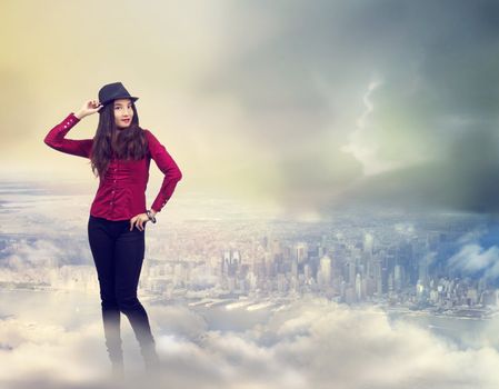 Happy Young Woman Standing on the Clouds Above the City