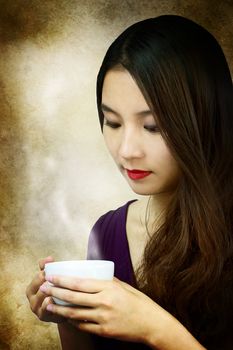 Beautiful young woman holding a coffee cup 