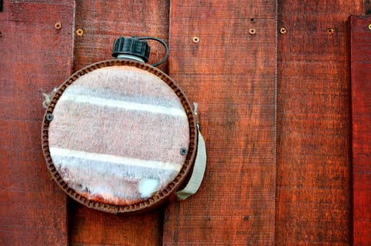 Old flask decorate on wooden wall