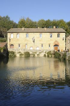 old thermal baths in the medieval village Bagno Vignoni, Tuscany, Italy - spa basin in the antique italian town