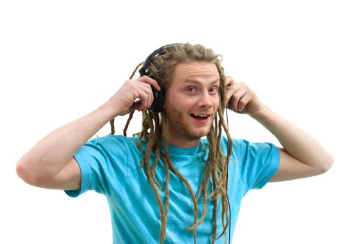 Portrait of a Young Man with Dreadlocks Listening to Music on Headphones 