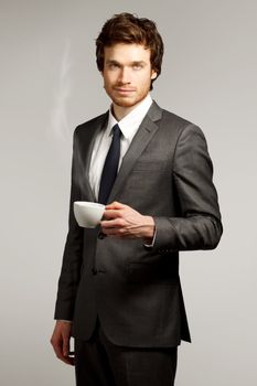 Young Business Man Drinking a Cup of Coffee or Tea