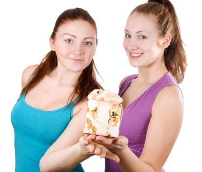 two happy beautiful girls holding a present isolated