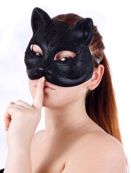 girl in the mask cat keeps his finger at the lips, to keep a secret