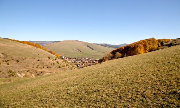 View of a village among hills in autumn 