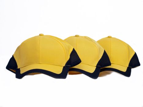 Three yellow baseball caps with black field