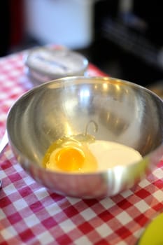 The making of a dessert topping with sugar and eggs