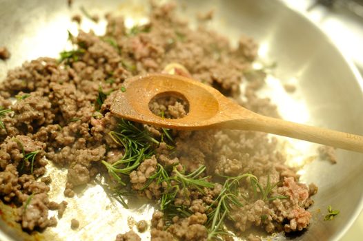The making of a dish of ragu with meat and vegetables