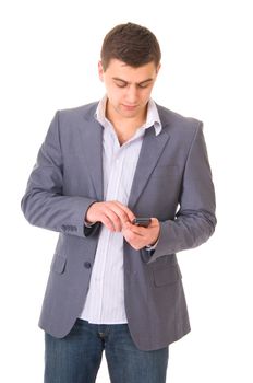 Yiung casual young man in jeans and jacket with phone isolated on white background