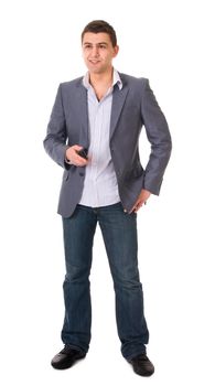 Young casual man in jeans and jacket with phone isolated on white background