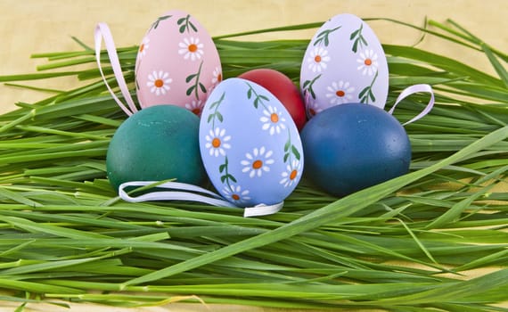 A collection of colorful easter eggs in grass nest