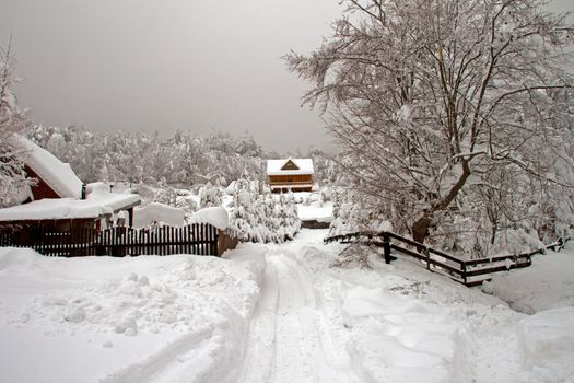 Snowy landscape with some wooden houses in Transylvania