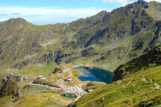 Ice cold blue lake in the mountain with tourist facilities