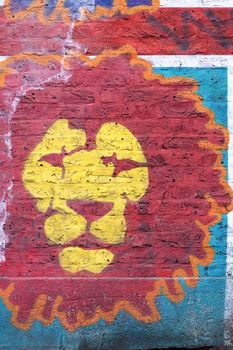 Closeup of a lion graffiti painted on a brick wall