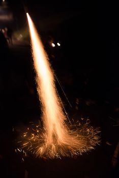Fireworks rocket being launched out of a champagne bottle on its way into the sky