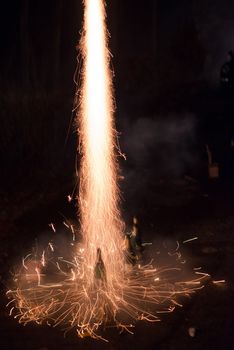 Fireworks rocket being launched out of a champagne bottle on its way into the sky