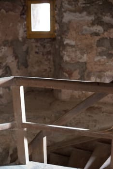 old wooden stairs in the roof of an abandoned building