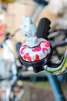 Detail of nice bicycle bell with toy parked in a center street of Amsterdam