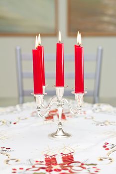 Five canles on a table in a candlestck