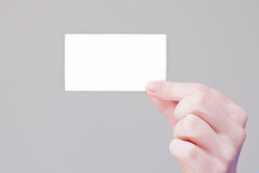 bussines card in hand for your information and logo in a grey background