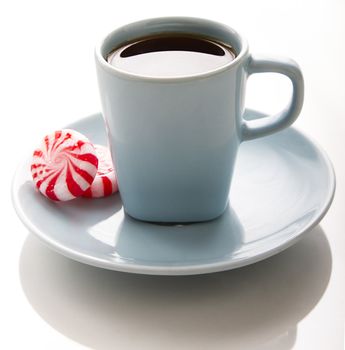 small blue coffee cup with red and white swirl mint