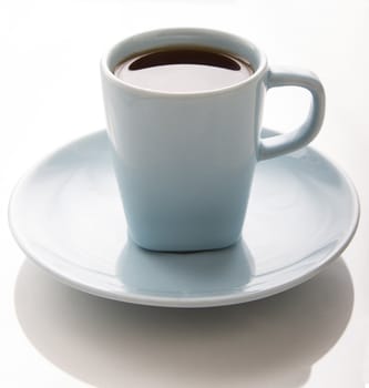 small light blue coffee cup against a white background