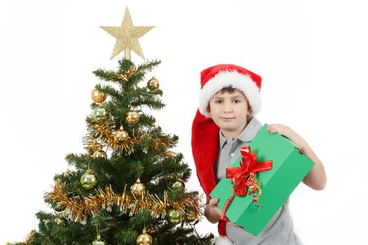 happy boy in santa hat show christmas present on white background