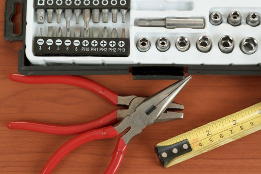 DIY work tools, screwdriver toolbox with set of bits, pliers and measuring tape