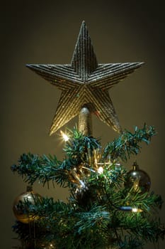 night scene with christmas star on tree with yellow and green balls