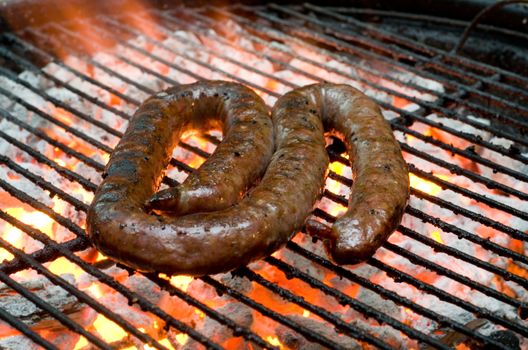 Tradtional South African braai barbecue borewors sausage on fire