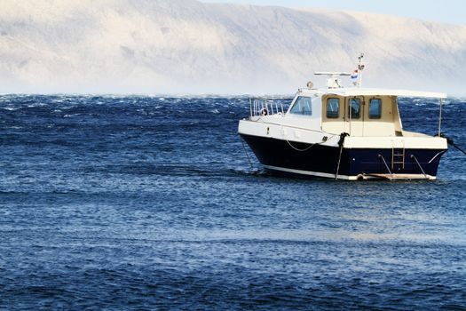 Small motorboat on the blue sea