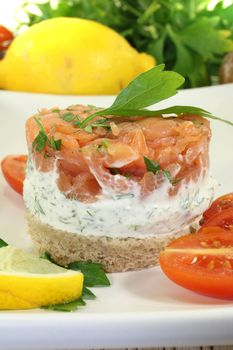 salmon tartare with creme fraiche, bread and parsley