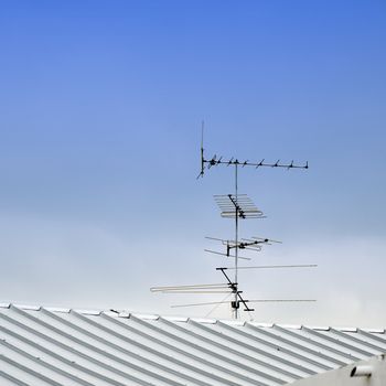 TV antenna on top roof with raining cloud